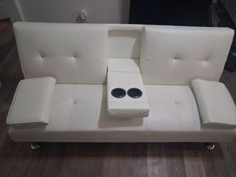 Renwick Luxury Goods Modern Faux Leather Futon with cup holders and pillows.