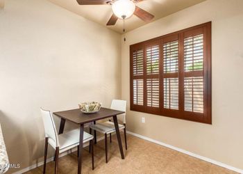Brown table and white leather chair set.