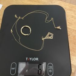 6 Grams Of 14 Kt Gold One Garnet Necklace And One Gold And Diamond Bell Necklace And One Earring 
