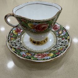 vintage bone china teacup and saucer set made by Windsor in England, featuring a decorative floral pattern.  Manufacturer: Windsor Material: Fine Bone