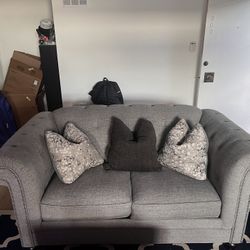 Gray Tufted Sofa with Decorative Pillows