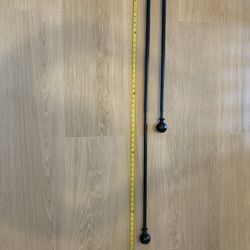 Two black curtain rods