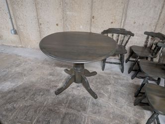 Dark gray round dining table and chairs set