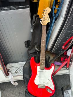 Squier by Fender Stratocaster electric guitar with a white pickguard