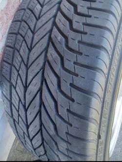 LIKE NEW CADILLAC RIMS AND TIRES