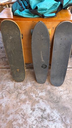 2 Skateboards and 1 skateboard with no wheels