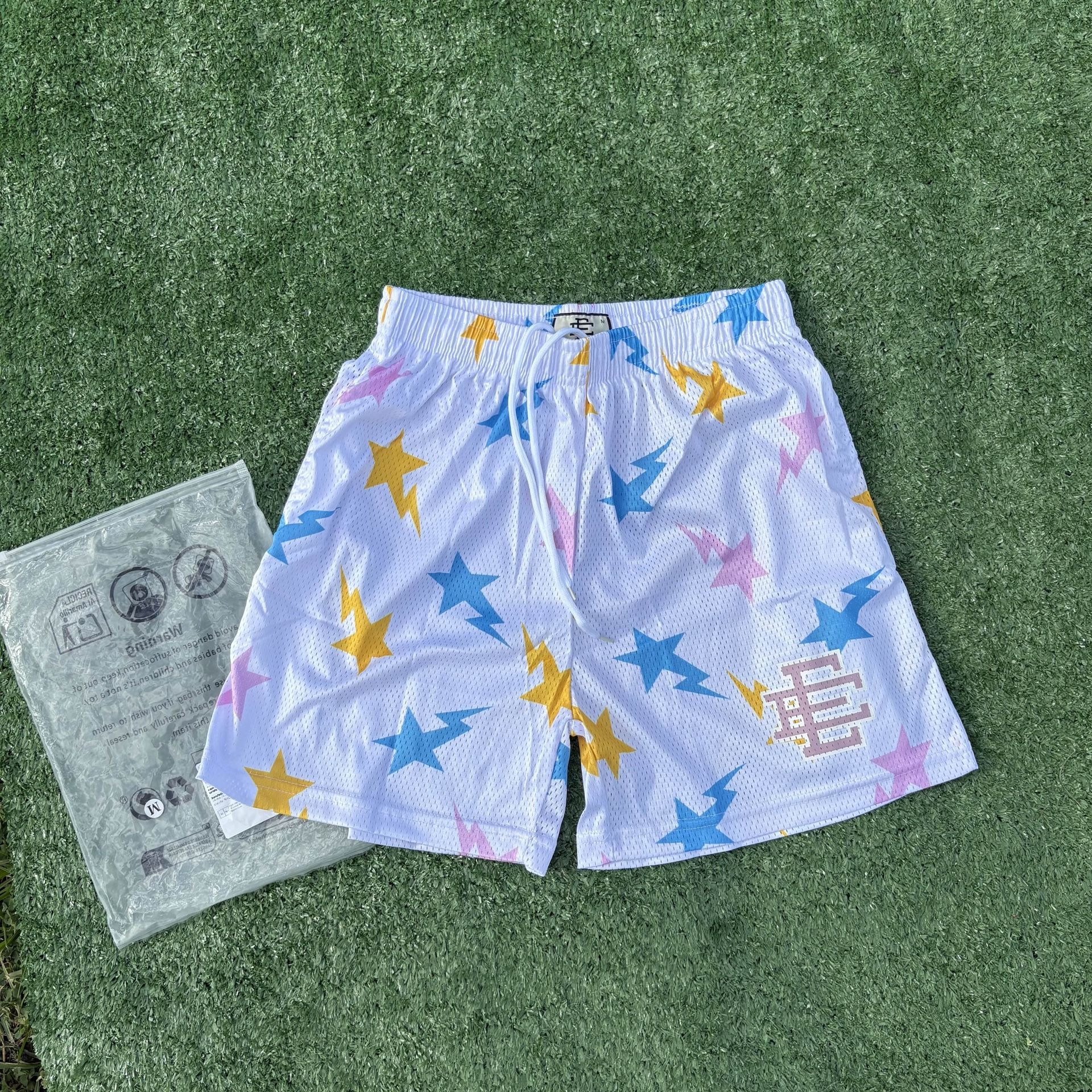 White Eric Emanuel shorts sith pink, blue and yellow stars size medium (brand new)