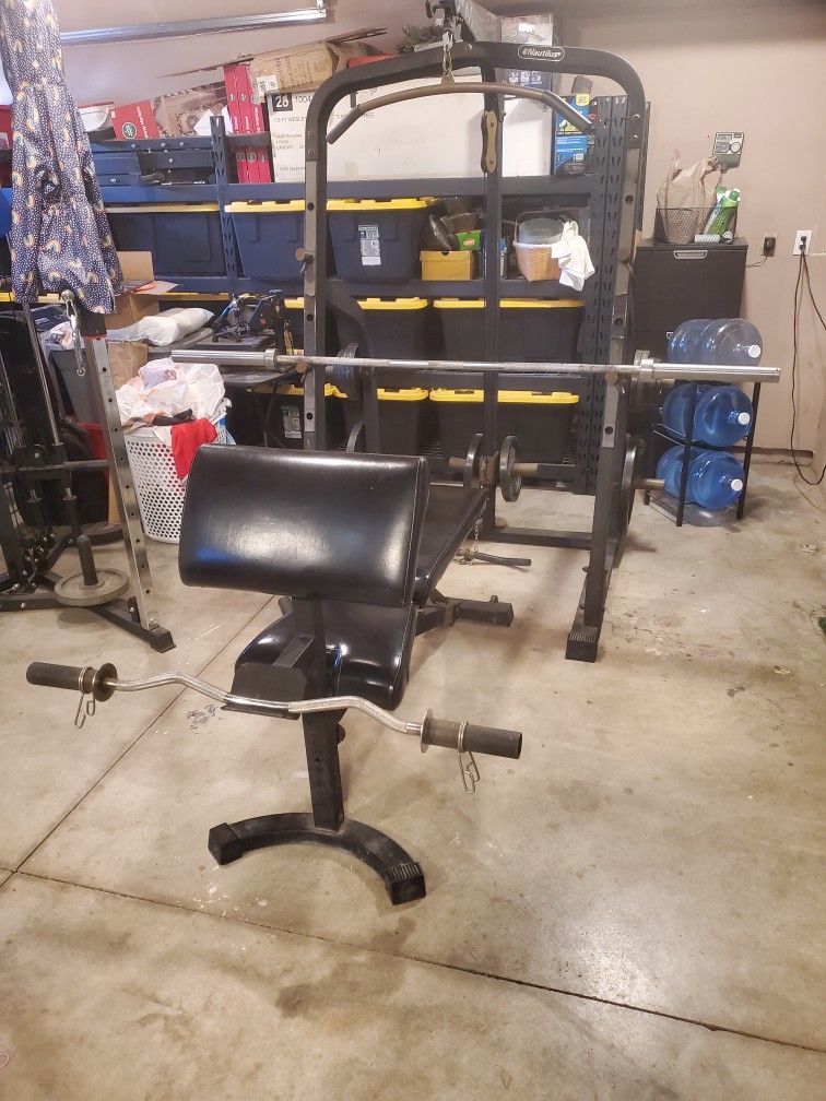 Nautilus bench press, squat rack, and pulley system.