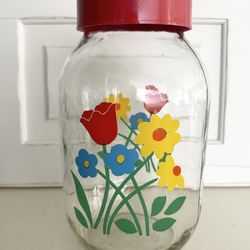 Vintage Carlton Glass Jar / Canister. Cute floral bouquet graphics are bright and shiny . Lid is plastic screw on.  Great condition.  10 1/2” tall ,  