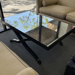 Mirror glass topped coffee table with black wooden base