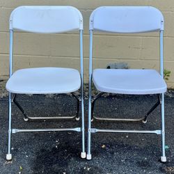 (2) White plastic folding chairs with metal frame. $10 each. Free to ask, I reply 