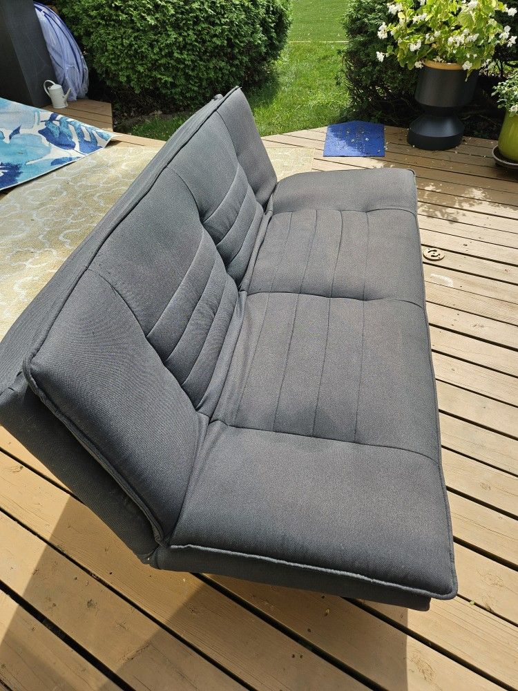 Futon Reclines Into A Bed, Good Condition Black In Color 6ft