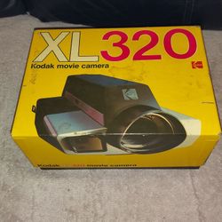 VINTAGE KODAK MOVIE CAMERA WITH SCREW ON HANDLE MODEL XL320 ORIGINAL BOX USES TYPE G160 FILM. IT HAS LONG CHROME METAL NECK STRAP.