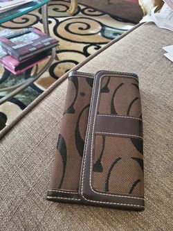 Beautiful brown wallet with magnetic closure and zipper on the back.
