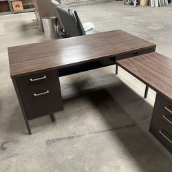 desk, tables and file cabinets. 