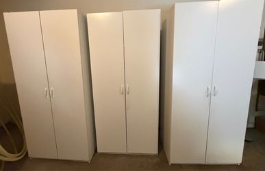 3 white storage cabinets