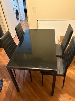 Dinning table with four chairs .