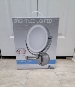 brand new bright led lighted cordless wall mount mirror. (MUST SELL TODAY)