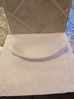 vintage white milk glass relish dish, often featuring a ribbed or hobnail texture and a scalloped or beaded rim.