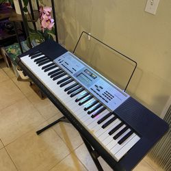 Casio Piano Keyboard 61 Keys- Works Perfectly. Sheet music display and keyboard stand included.