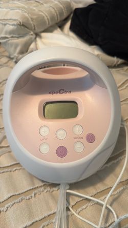 Spectra S2 Breast Pump Pink with some accessories and instructions