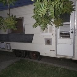 Rv Living Room And Sleeping Quarters And Stove And Bathroom