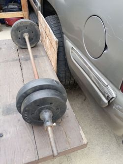 Barra con 4 pesas en total 50 libras