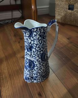 A vintage Japanese blue and white porcelain pitcher with phoenix motifs.
