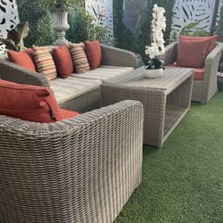 Beautiful 4-piece wicker patio set in good condition. Both sofa seat cushions need replacing.