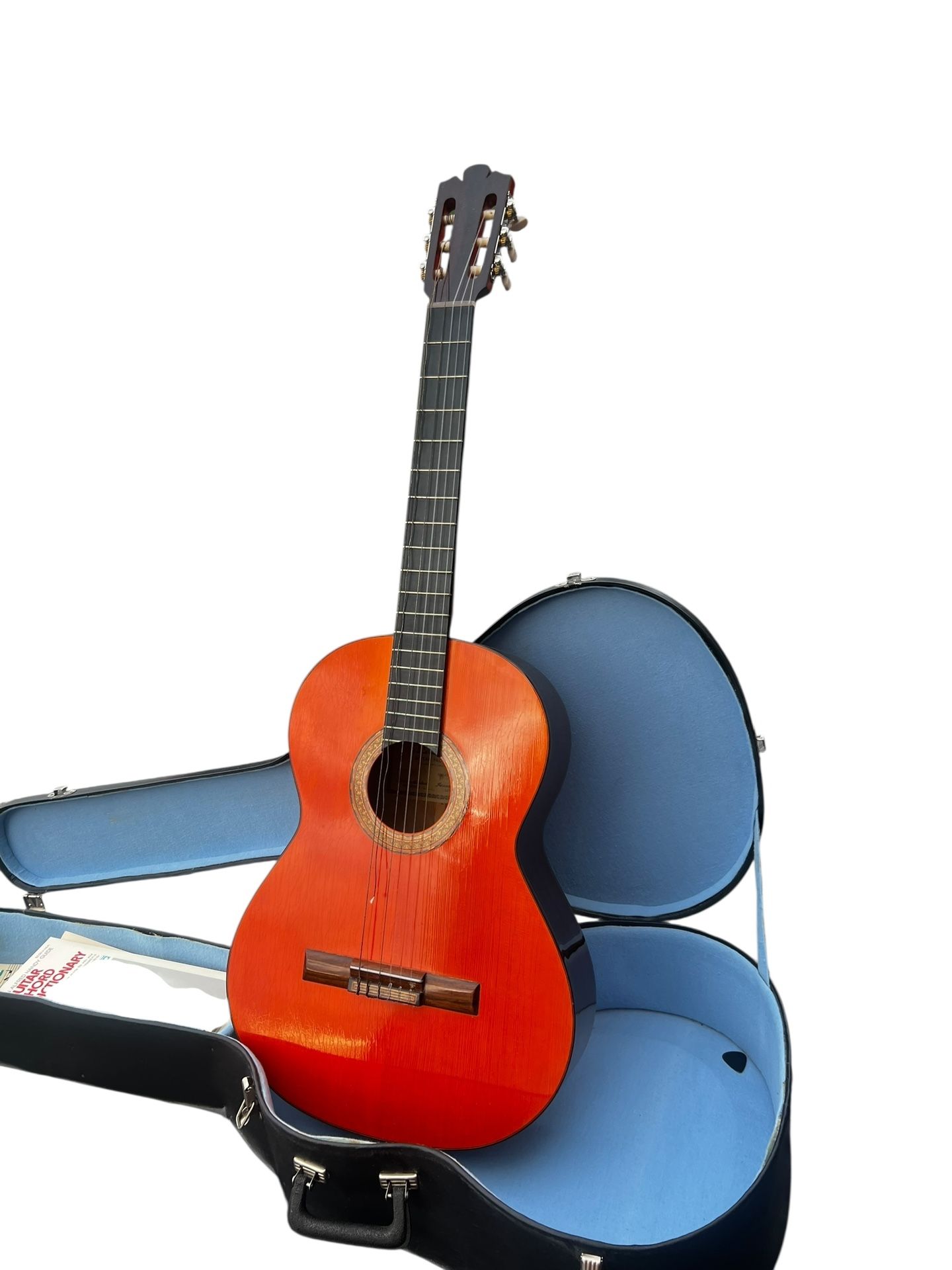 Vintage 1980’s Lilang’s Guitar Factory Acoustic Guitar with Case and String. Has a broken string. Some cosmetic wear on Guitar, lots of wear on case. 