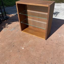 hanging display or storage cabinet with a warm wood finish and two removable glass shelves