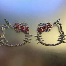 A dazzling pair of Hello Kitty fashion clip-on earrings. These iconic cat face silhouettes are framed with sparkling clear rhinestones, and feature a 