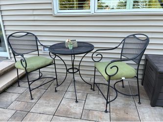 Three-piece metal bistro set with cushions