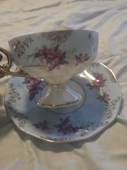 vintage Royal Sealy teacup and saucer set with a floral pattern and gold trim. 