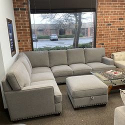Gray fabric sectional sofa with storage ottoman