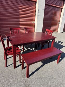 Wooden table and four chairs and a bench