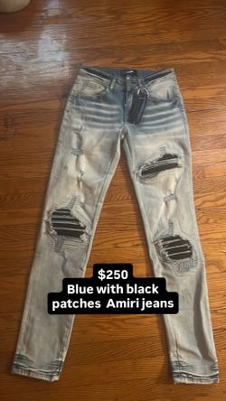 Blue Amiri jeans with black patches