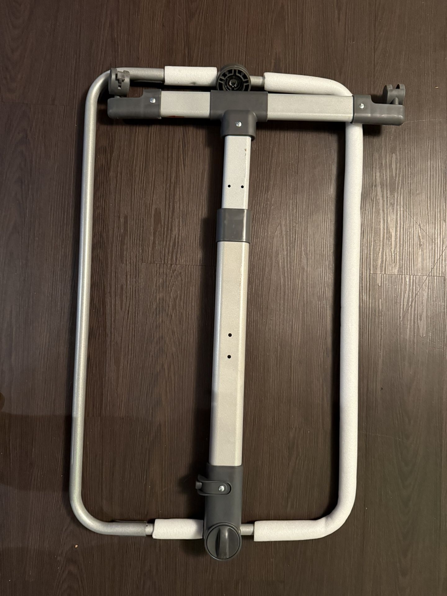 Part of the frame of a child’s playpen and detached fabric-mesh tent from the playpen