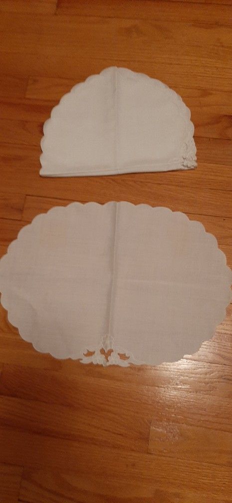 White scalloped table linens with decorative cutouts.