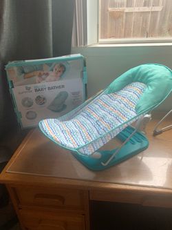 Baby bather , very clean  $15 . Changing pad for table $10  no tears clean  , cash .