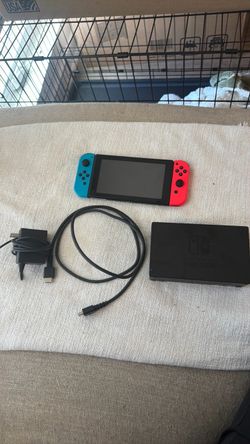 Nintendo Switch with charger, HDMI cord and TV adapter