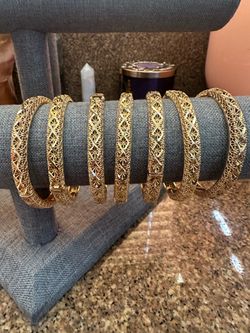 7 gold plated bangles (they open to fit)