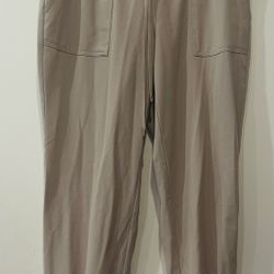High-Waisted StretchTech Performance Cargo Jogger Pants in a taupe/beige color. 