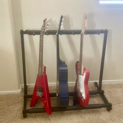 Guitar Stand With 3 Kids Guitars. One Is From Guitar Center-Fender. 