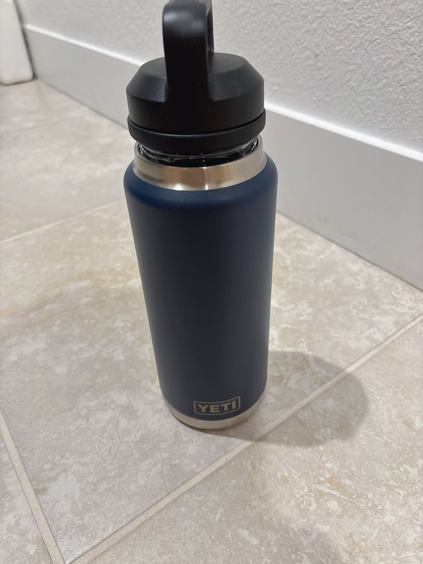 Brand new YETI-Rambler Vacuum Bottle with Chug Cap - 36 fl. oz-Color: Navy Features 2-part cap is topped with a TripleHaul™ handle for grab-and-go eas