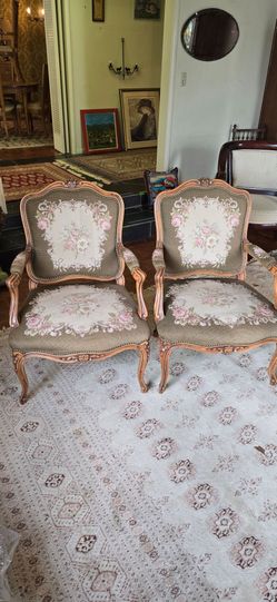 This French Louis XV style armchair features a decorative needlepoint tapestry
