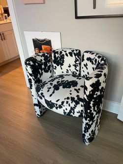 3 piece cow print rug and two cow print chairs