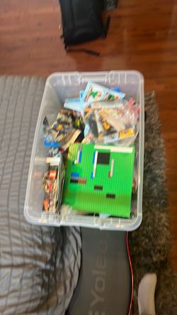 A bucket full of legos and unfinished sets