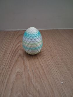 3D printed dragontoy.Brown eyes and rainbow egg