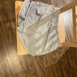 Nike One Women's Dri-FIT Ultra High-Waisted 3" Brief-Lined shorts in a tan/neutral. Size small